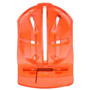 Detail view of the orange golf ball liner clip showing the inner metal spring mechanism