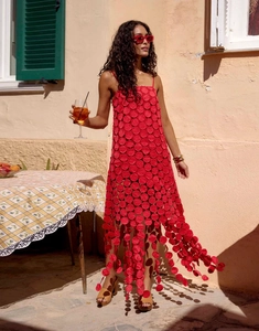 Detail of red hollowed-out dot fabric and tassel hem on a French style summer dress