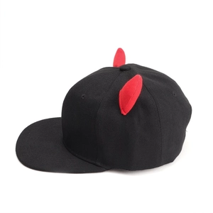 Detail of red demon horns on a black flat brim hip hop cap made of premium cotton twill