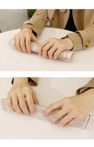 Close-up of minimalist S925 sterling silver stacked rings on hand with textured finish