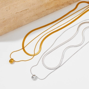 Minimalist double-layered gold and silver waterdrop pendant necklaces on white background