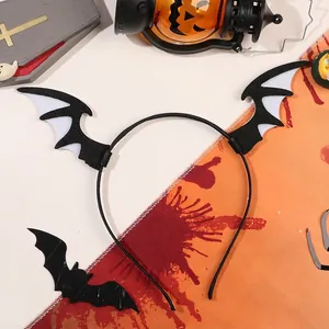 Close-up of Halloween headband featuring felt bat wings against a spooky festive backdrop