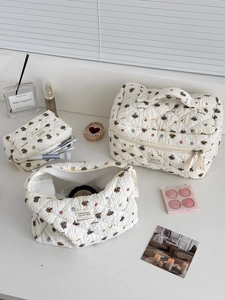 Detailed set of three quilted makeup bags with cute bear print and soft cotton texture
