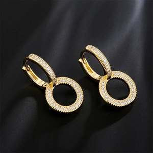 Gold plated hoop earrings with micro-pave cubic zirconia on black texture background