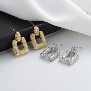Elegant 18K gold and silver geometric earrings with textured rectangular pendants