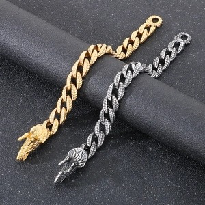 Detailed close-up of gold and silver dragon scale bracelets with ornate dragon head clasps