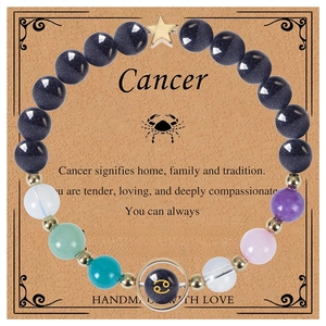 Detail of Cancer zodiac beaded bracelet with blue goldstone and gold star charms