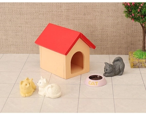 Miniature dollhouse pet scene with cat house, figurines, feeding bowl and plant detail