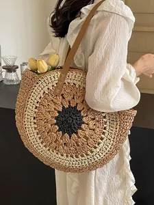 Handcrafted circular paper rope woven tote bag with a sunburst pattern and brown straps