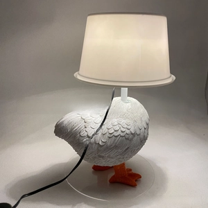 Detailed view of creative resin chicken lamp showing realistic white feather textures