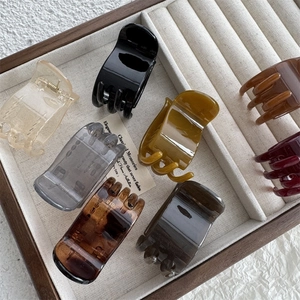 5cm minimalist hair claw clips in assorted glossy colors on a jewelry display tray