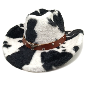 Western cowboy hat featuring black and white cow print with a silver bull head ornament