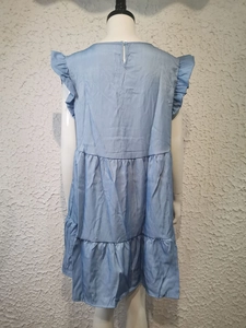 Detail of light blue denim dress featuring ruffle sleeves and back button closure
