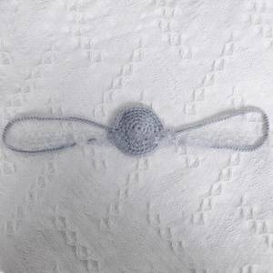Detail shot of a handmade gray crochet funny nose prop with side loops for party wear