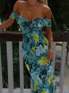 Outdoor shot of a strapless floral dress with ruffle details in a tropical setting