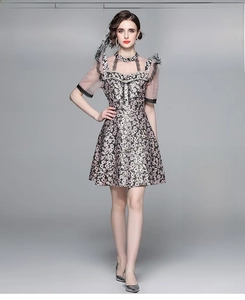 Detailed view of floral vintage dress featuring pearl-beaded collar and sheer puff sleeves