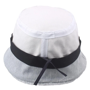 Detailed shot of frayed denim edges and black ribbon tie on a two-tone bucket sun hat