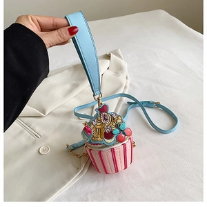 Detail of pink and blue cupcake-shaped PU leather bag with delicate embroidery