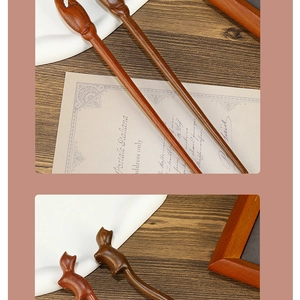 Close-up of hand-carved sandalwood hairpins featuring cute cat-shaped tops and polished finish