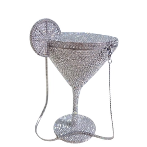 Detail of silver martini glass clutch bag with sparkling rhinestones and metal chain