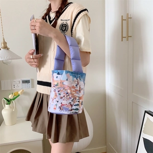 Detail of quilted lavender handle and vibrant cartoon town illustration on canvas bag