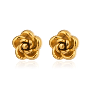 Detailed close-up of elegant gold-tone rose earrings with polished metal texture