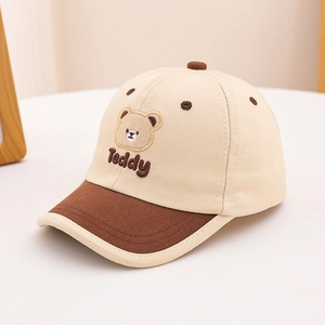 Close-up of Teddy Bear embroidery on two-tone beige and brown cotton baseball cap