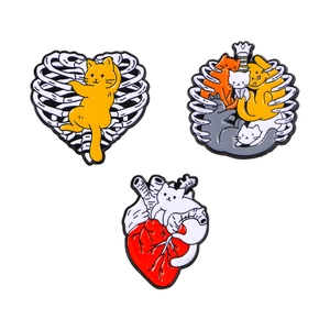 Three-piece set of cartoon cat enamel pins featuring skeleton ribcage and heart designs