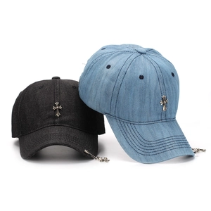 Denim baseball caps in black and light blue featuring vintage metal cross accessories
