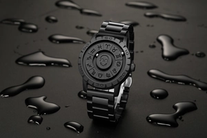 Detail of magnetic ball watch featuring a skull relief and zodiac symbols with water droplets