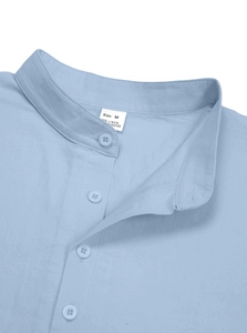 Close-up of light blue linen shirt collar showing size M label and fabric composition