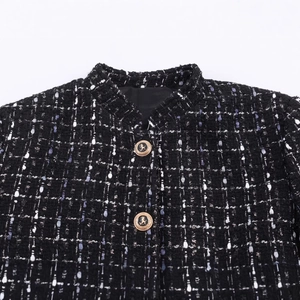 Women's black tweed jacket with metallic textures and lion embossed gold buttons