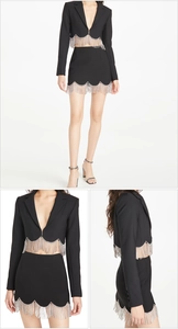 Detail of black blazer and skirt set featuring sparkling silver rhinestone tassel fringe