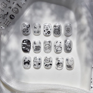 Detailed view of 3D embossed nail stickers featuring black cats and silver glitter stars