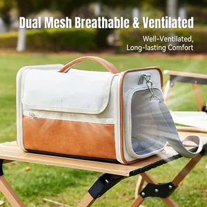 Portable pet carrier bag in canvas and leather with mesh window on outdoor table