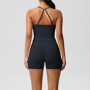 Detail of black cross-back yoga jumpsuit showing open back design and elastic fabric