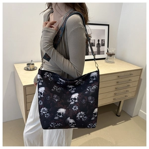 Detail view of gothic nylon bucket bag featuring skull floral prints and jacquard strap