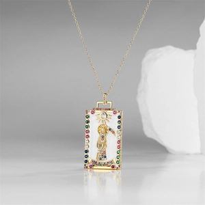 Macro detail of tarot death card pendant with gold base and colorful zircon inlays