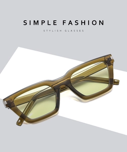 Detail of transparent yellow-brown stylish sunglasses with thick frames and light lenses