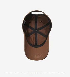 Detailed interior of brown cotton baseball cap showing reinforced seams and sweatband