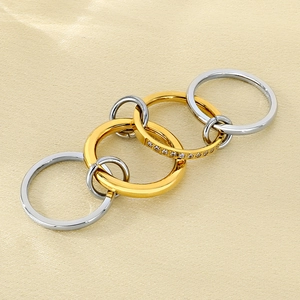 Detail of interlocking gold and silver layered rings with sparkling diamond accents