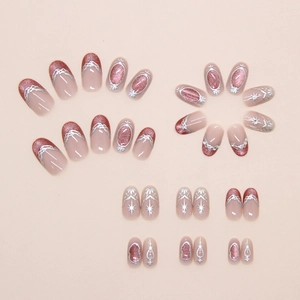 Detail of rose gold cat-eye press-on nails with baroque silver frames and star motifs