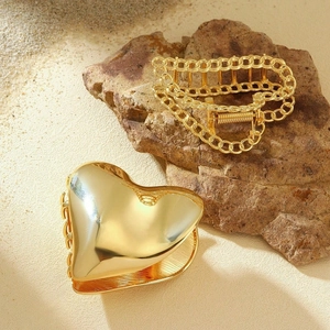 Elegant gold metal heart and hollow chain claw clips set on a natural stone background