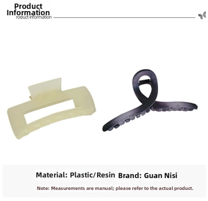 Detail view of large matte hair claws in rectangular yellow and twisted purple resin styles