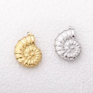 Macro view of gold and silver conch shell pendants with top loops for DIY jewelry making