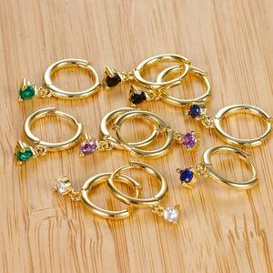 Close-up of five pairs of gold S925 sterling silver hoop earrings with multi-colored zircons