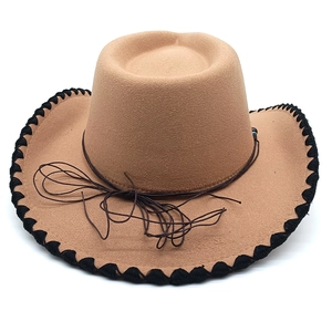 Detail of khaki felt cowboy hat with black braided brim edge and brown rope band