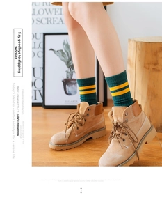 Close-up of camel suede ankle boots paired with green and yellow striped knit socks