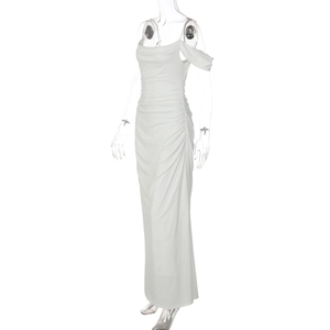 Detail of white maxi dress showing lateral layered pleats and side ruched texture