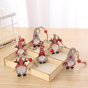 Detailed view of handcrafted wooden gnome ornaments with red beads and twine hangers